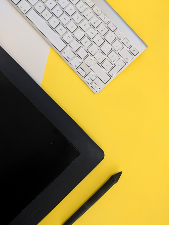 Wacom tablet and keyboard on yellow background